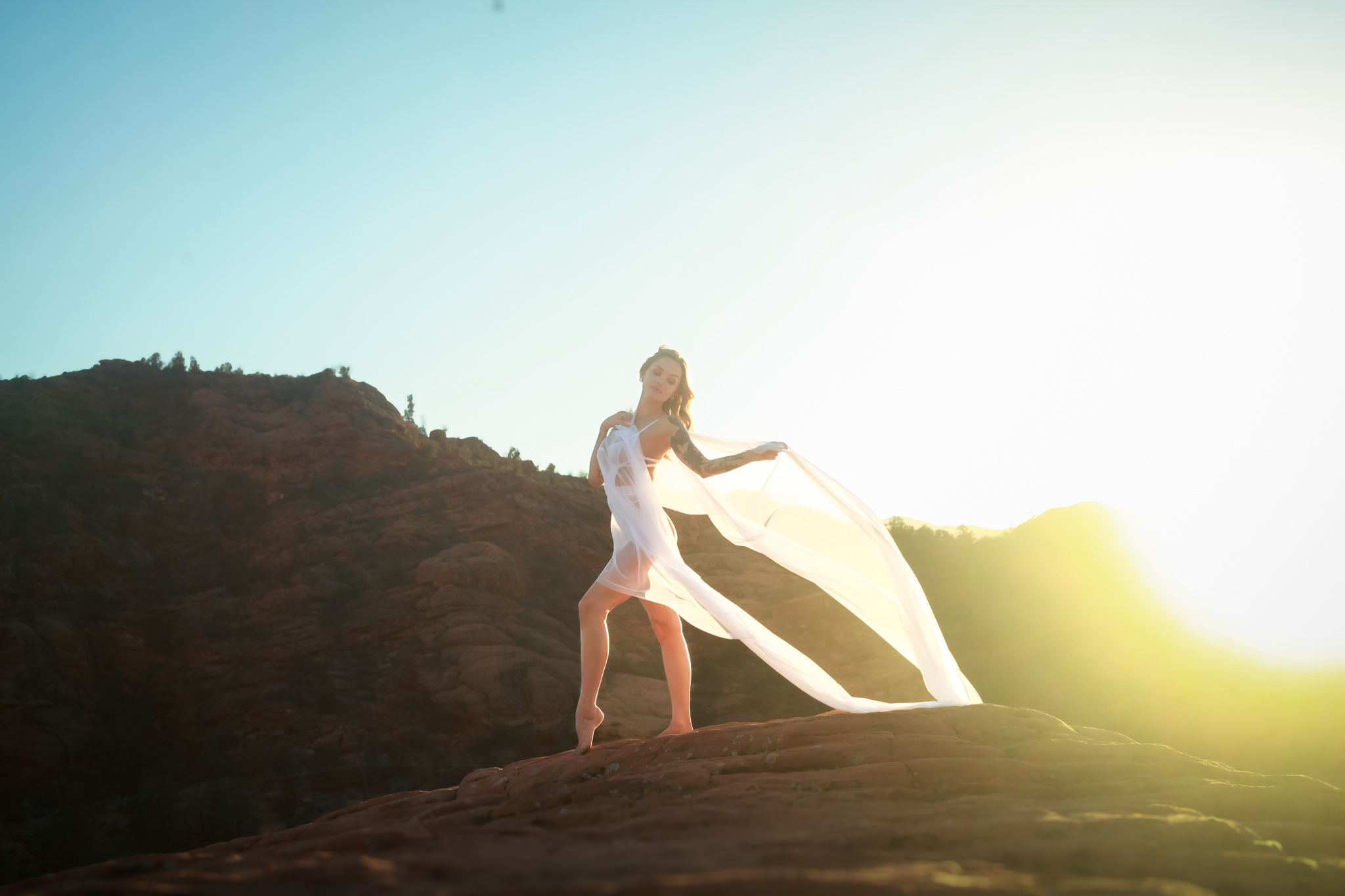 Woman in white on mountain.