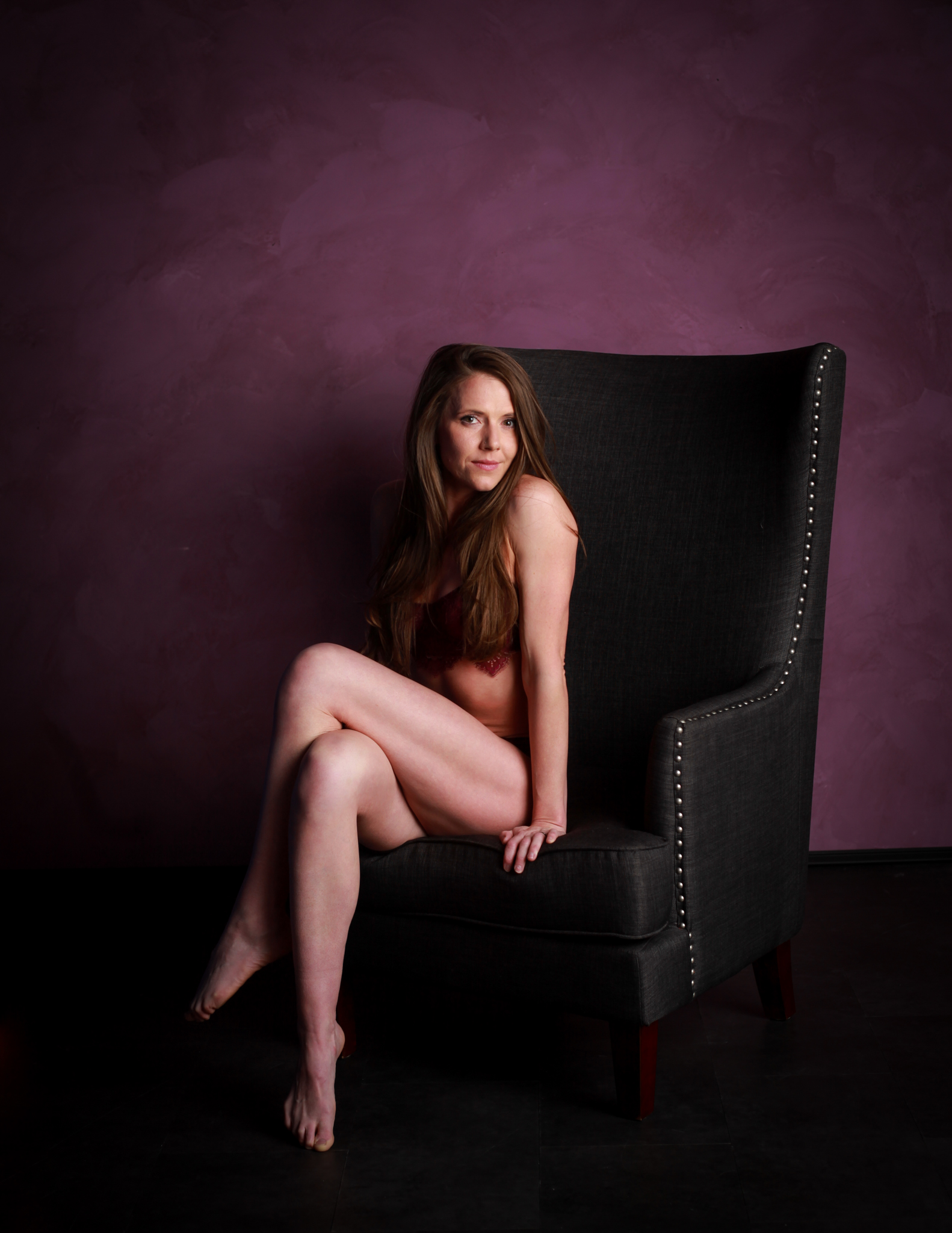 Woman in lingerie sitting on chair.