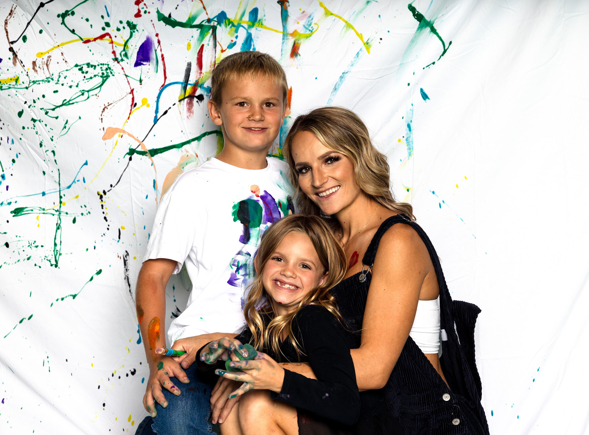 Mom and children painted posing.