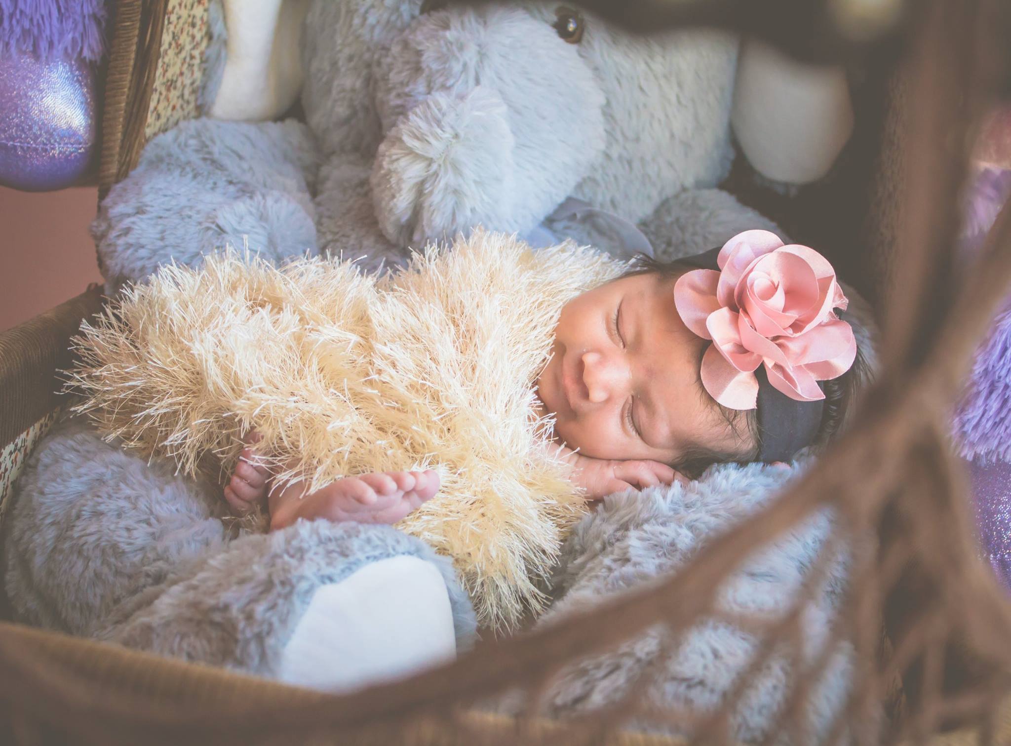 Baby wrapped in furry blanket.
