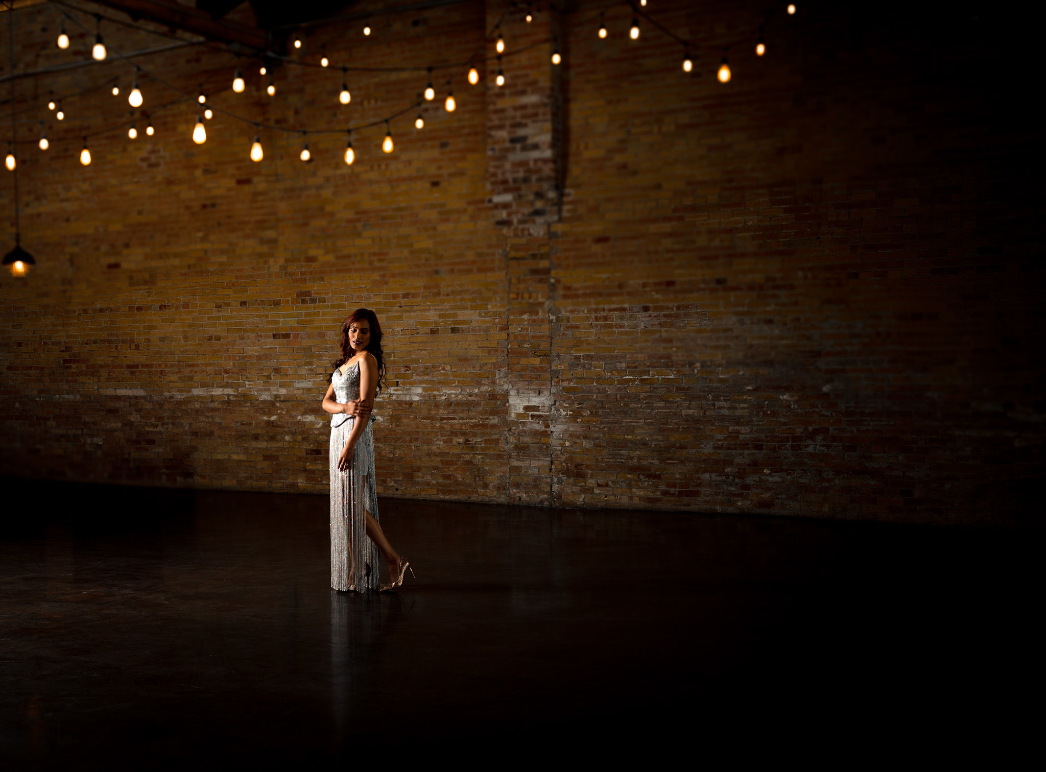Woman in fancy dress with twinkle lights.