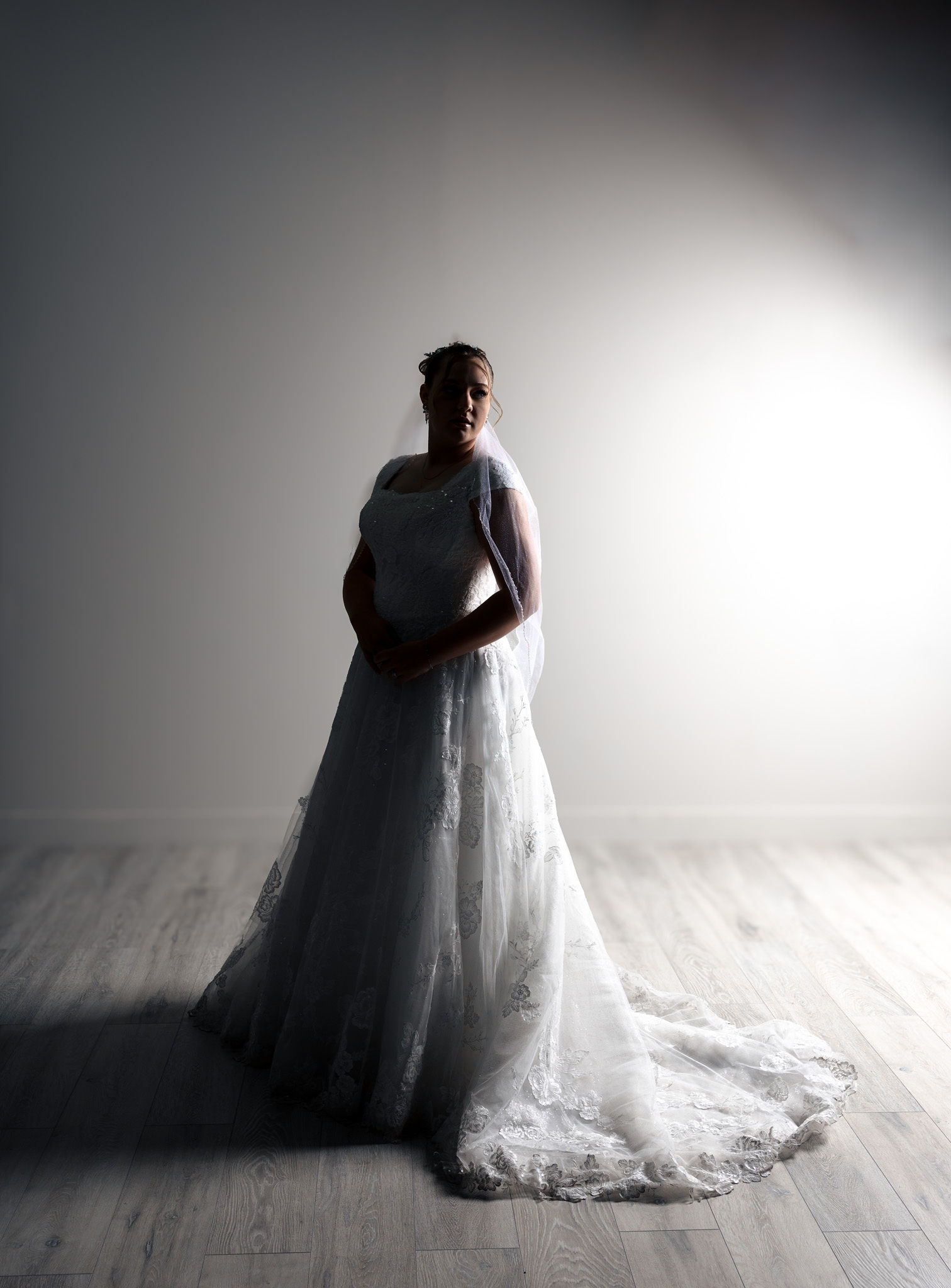 Bride on white with dramatic lighting.