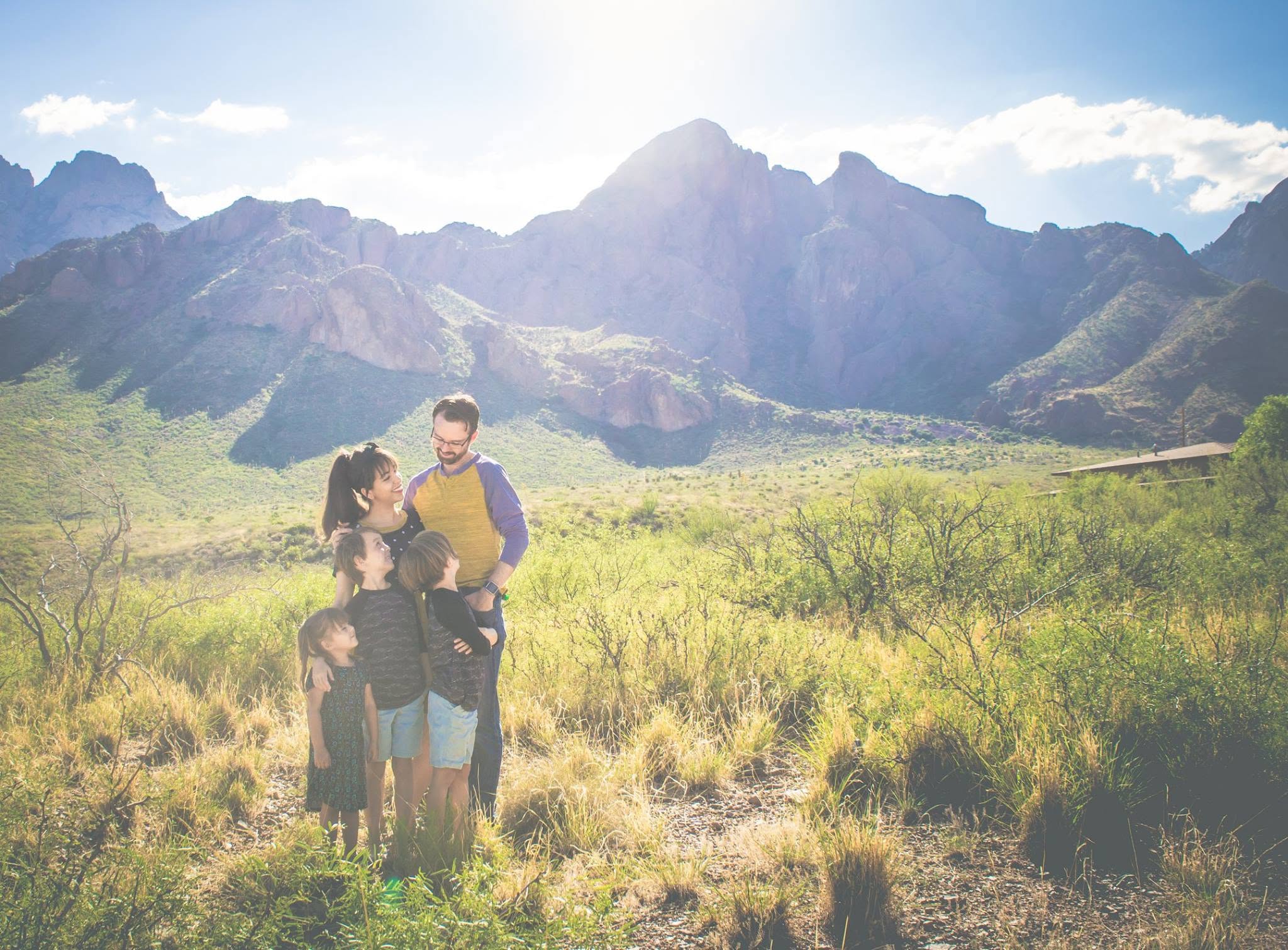 Small family with New Mexico mountains.