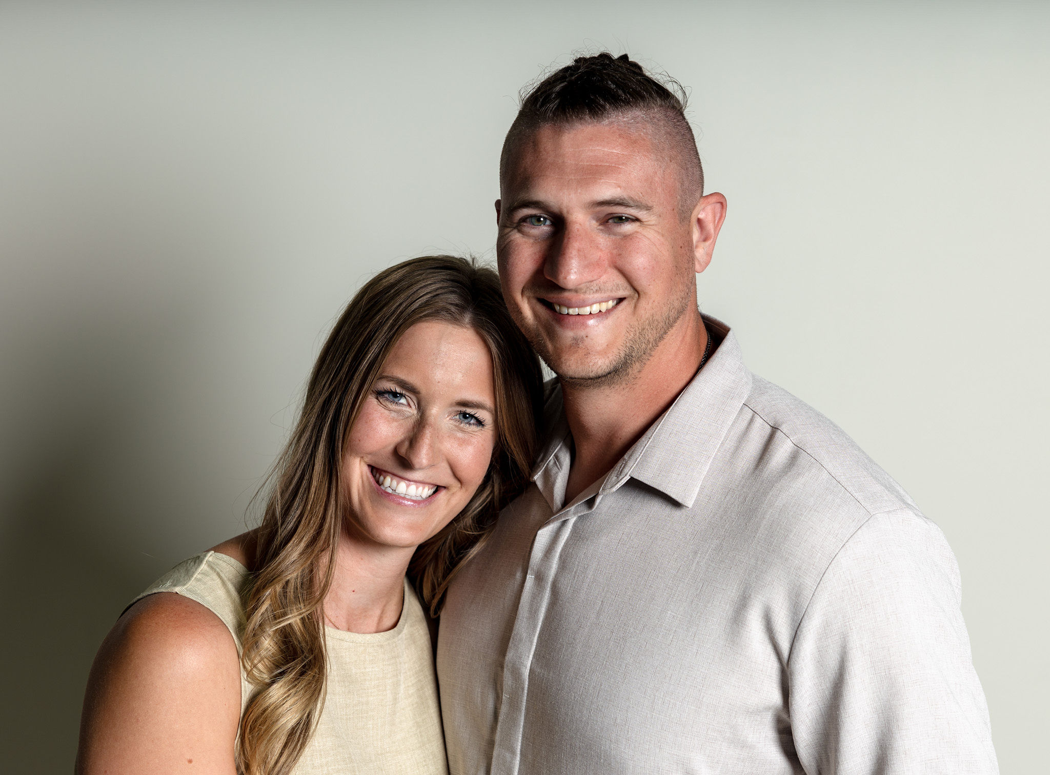 Husband and wife casual on white.