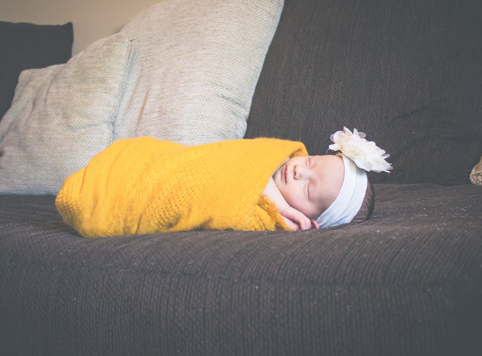 Baby girl in yellow wrap.