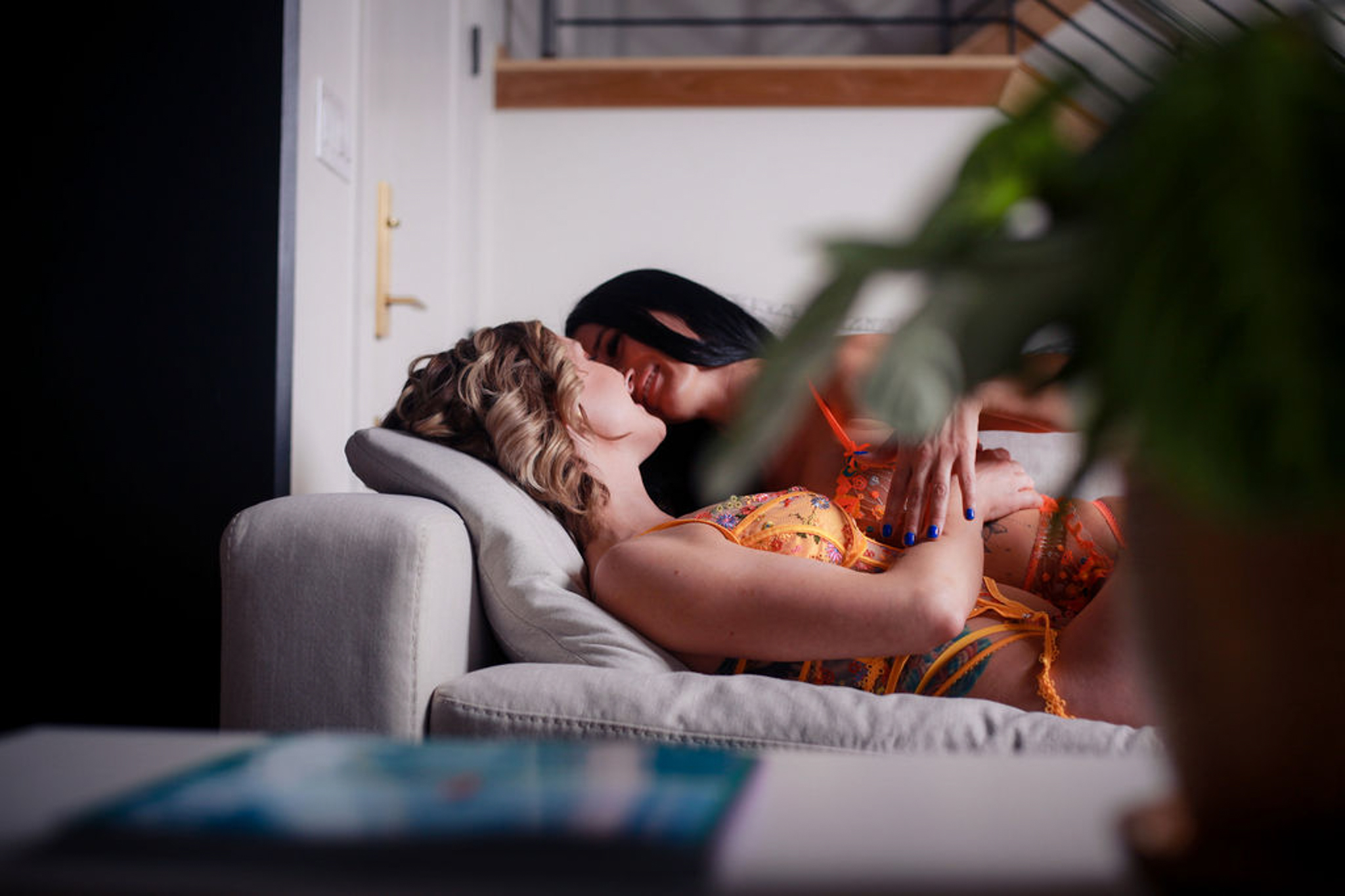 Female couple laying on couch.