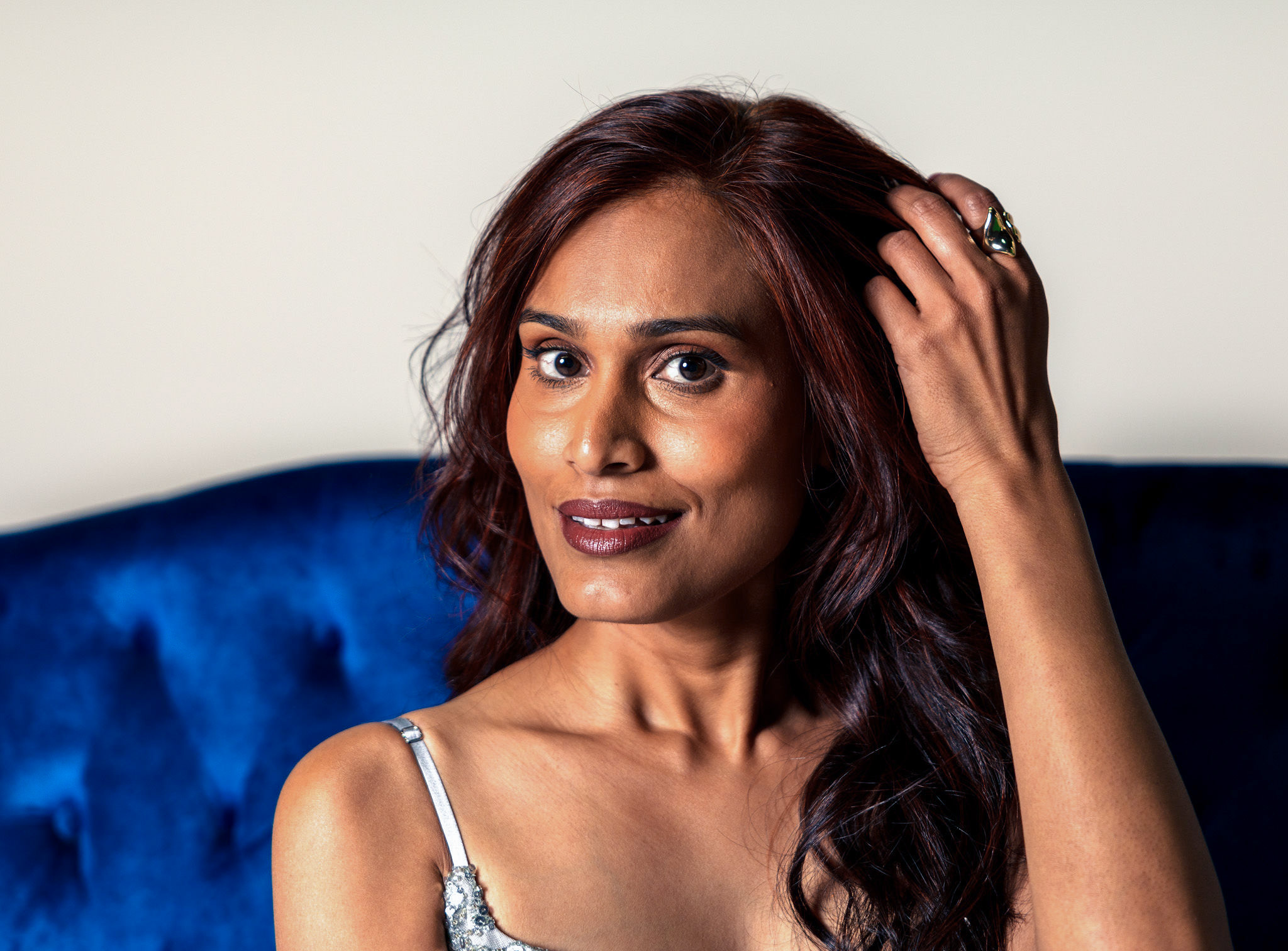 Woman with long hair brushing it to the side.