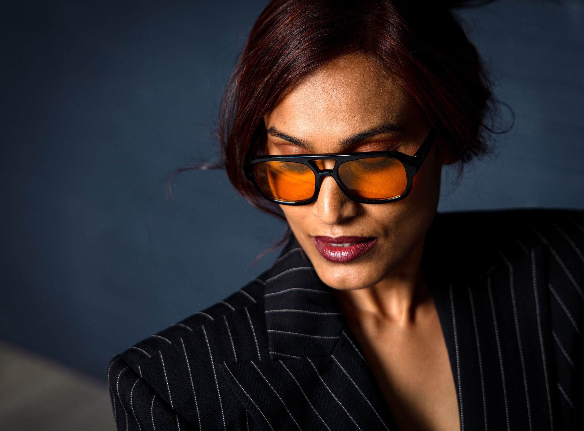 Woman in sexy suit looking down.